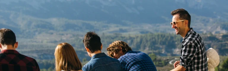 people feeling good on the edge of a mountain