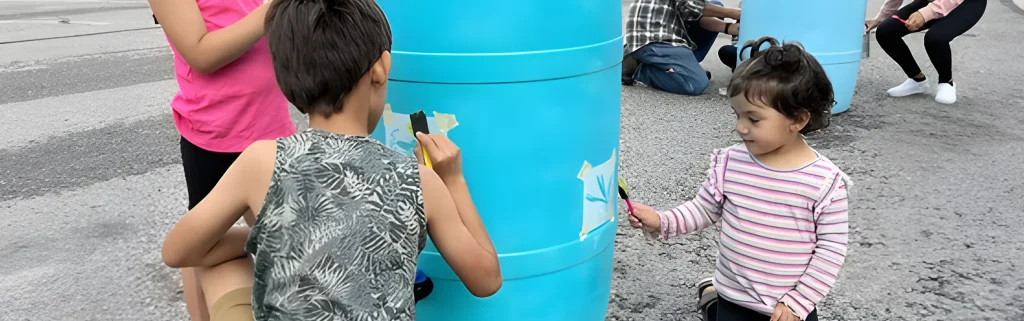 kids painting rain barrels